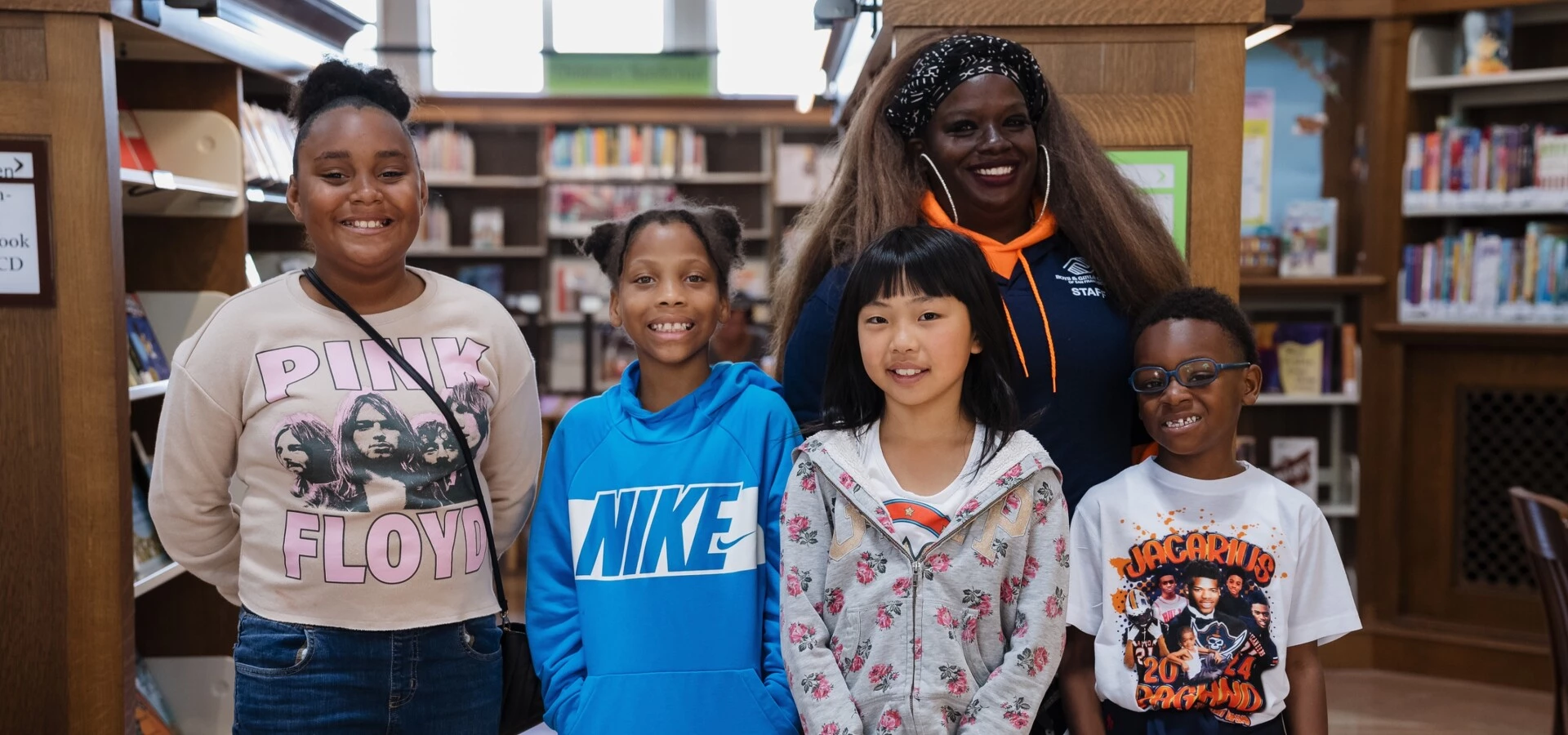 Four kids with Boys and Girls Club staff